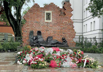 Kawałek muru, krzyż, napis. Historia Pomnika Powstańców Warszawskich w Słupsku